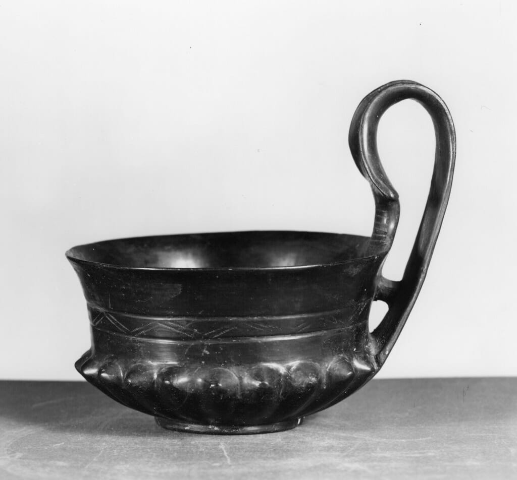A museum photograph of an Etruscan bucchero vessel from the seventh century BC